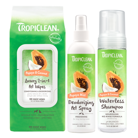 TropiClean Waterless Papaya & Coconut Dog Grooming 3 Kit. Tropiclean pet care products including wipes, spray, and shampoo on a white background