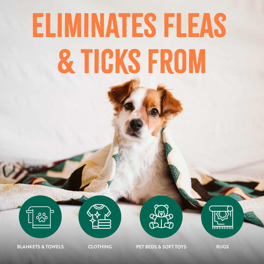 TropiClean Natural Flea + Tick Laundry Additive. Dog sitting on a blanket with text 'Eliminates fleas & ticks from' and icons below.