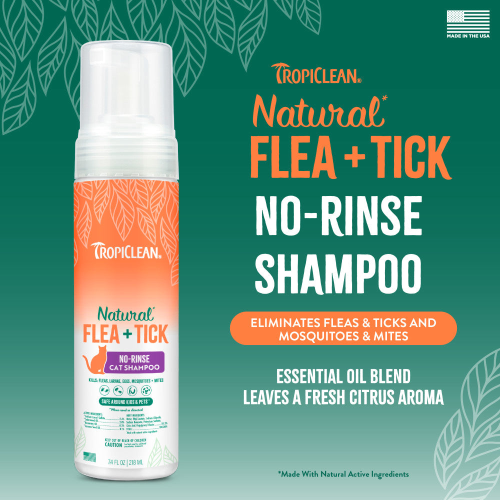 TropiClean Natural Flea + Tick Waterless Shampoo for Cats, bottle on a green background with product details.