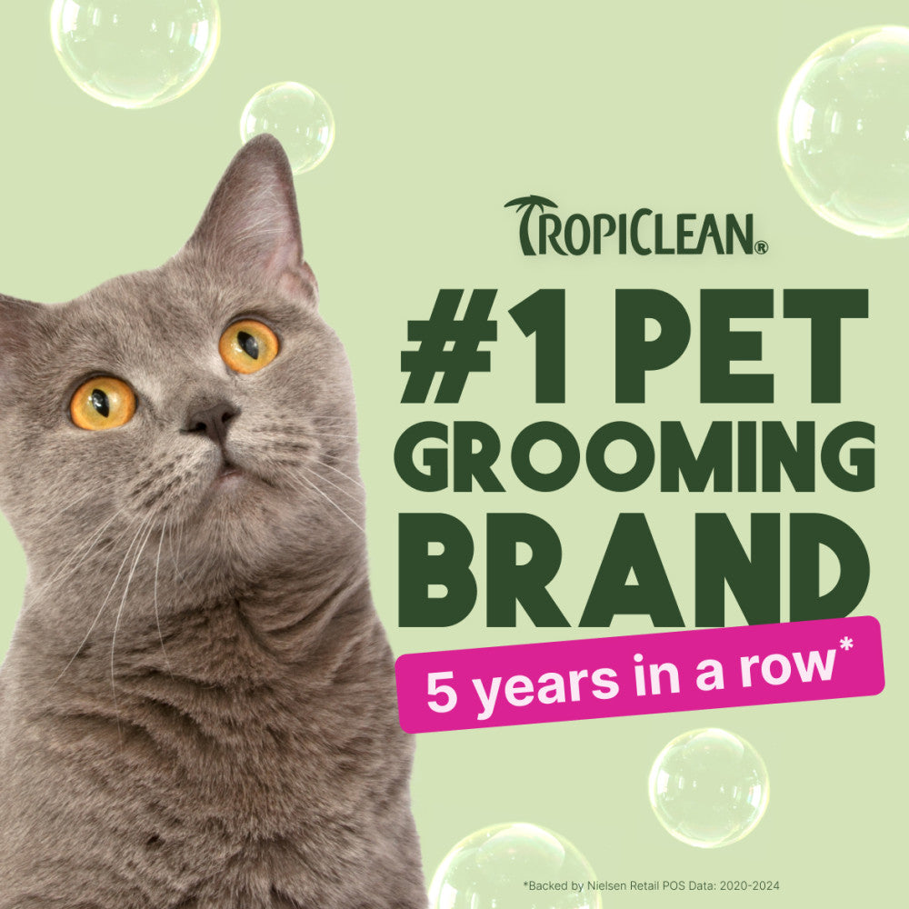 Gray cat with Tropiclean branding claiming to be #1 pet grooming brand for 5 years in a row on a light green background.
