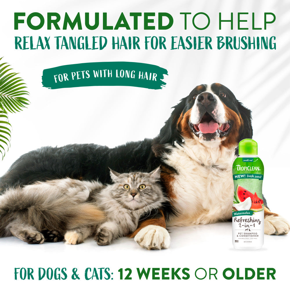 Dog and cat lying together with a bottle of TropiClean Watermelon Refreshing 2-in-1 Pet Shampoo & Conditioner