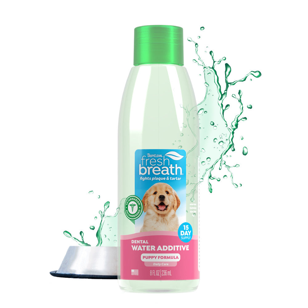 TropiClean Fresh Breath Oral Care Water Additive for Puppies, front view of 8oz bottle with dog bowl of water