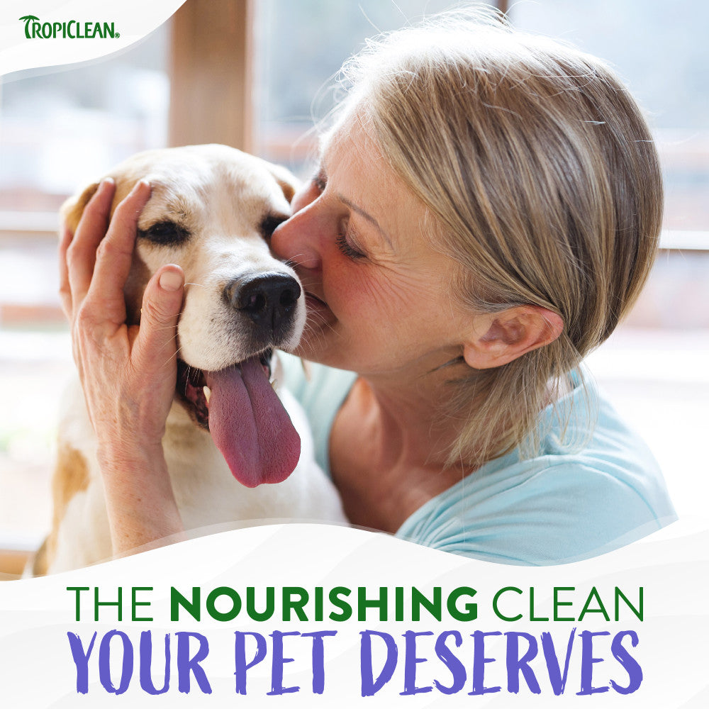 Woman kissing a dog with TropiClean logo and text about pet care.