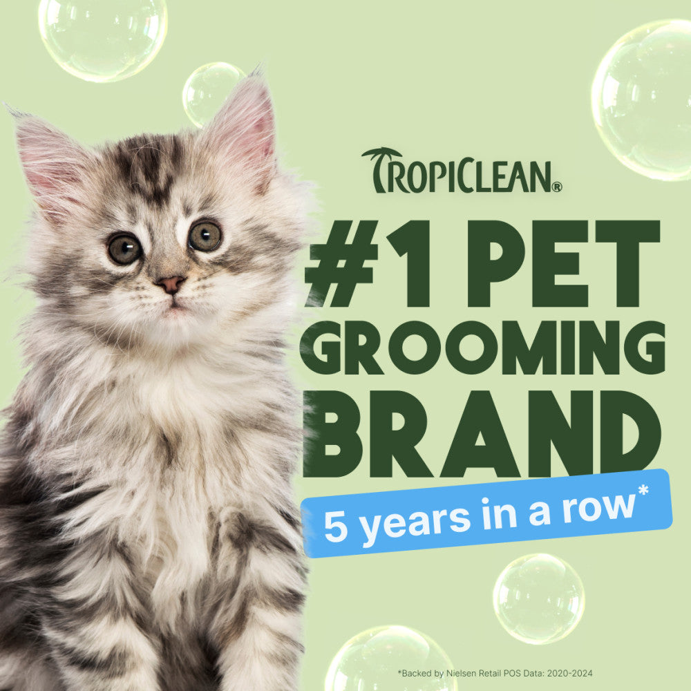 Kitten with Tropiclean branding claiming to be #1 pet grooming brand for 5 years in a row on a light green background with bubbles.