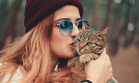 Blog: From Tear Stains to Tangle-Free Coats: Cat Care Made Simple with TropiClean. Woman kissing cat.