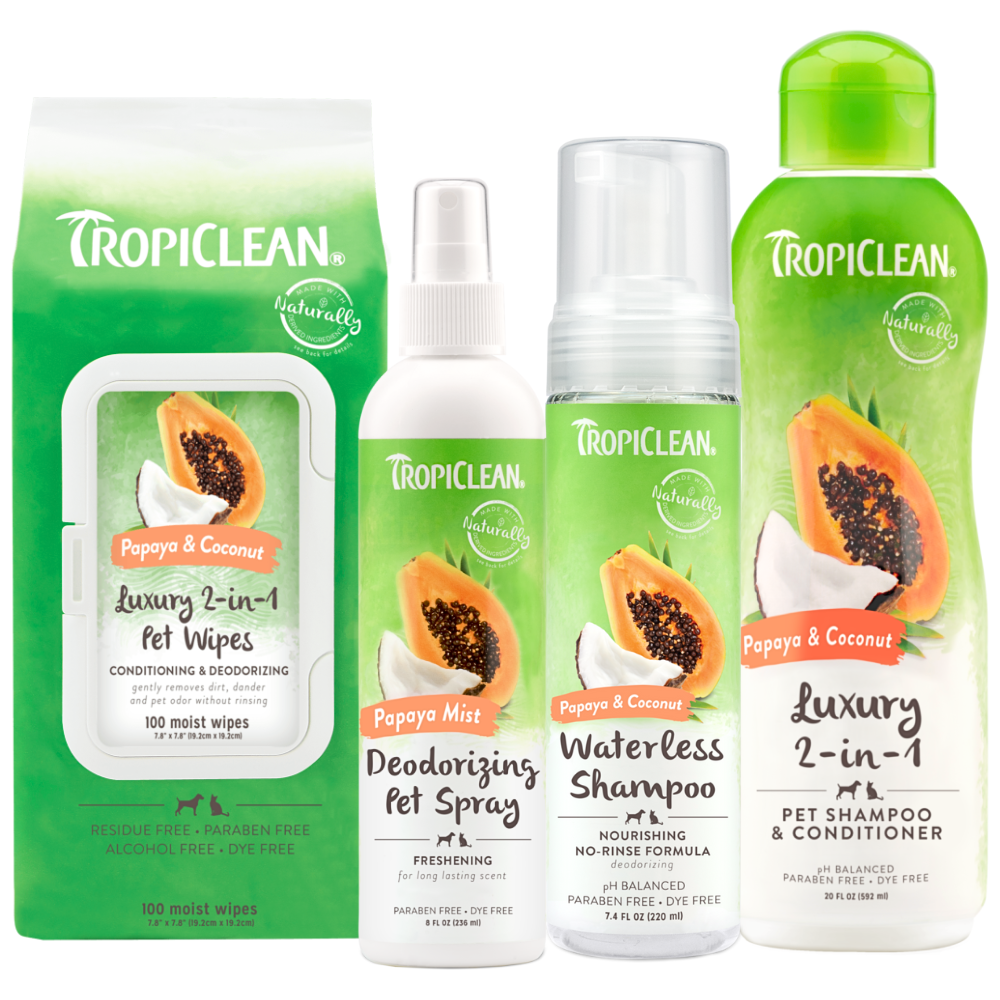 TropiClean Papaya & Coconut Pet Grooming Essentials 4 Kit. Tropiclean pet care products including wipes, spray, and shampoo on a white background