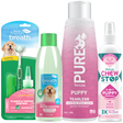TropiClean Puppy Grooming Starter 4 Kit. Collection of puppy care products including a shampoo bottle, dental water additive, and chew stop spray on a white background.
