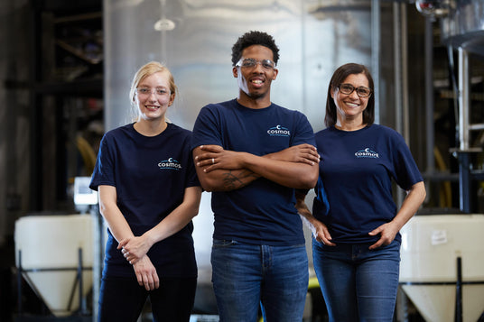 Three employees of TropiClean Cosmos standing together in company logo t-shirts