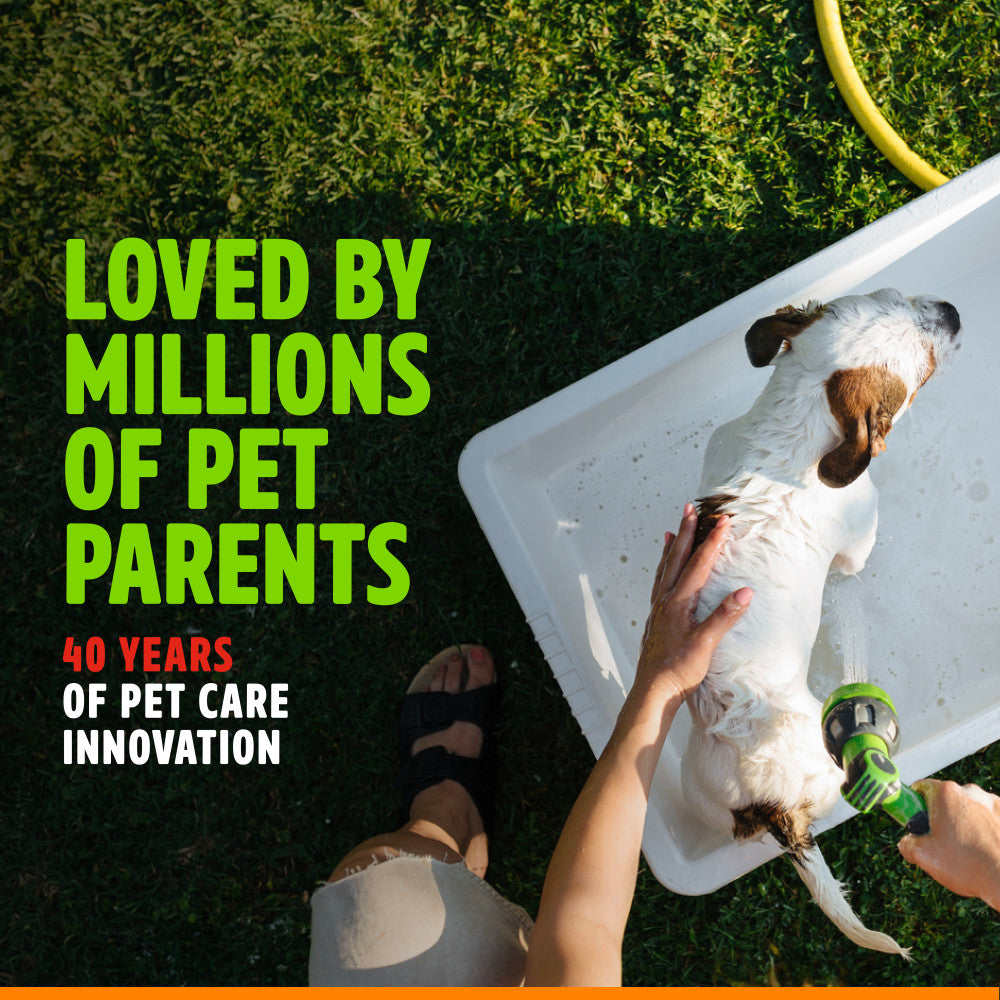 Dog being bathed with TropiClean EnduraScent Mango Kiwi Pet Deodorizing Spray, text about pet care innovation on a grassy background