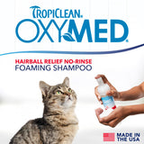 TropiClean OxyMed Waterless Dry Shampoo for Cats, image of cat and a hand with the product