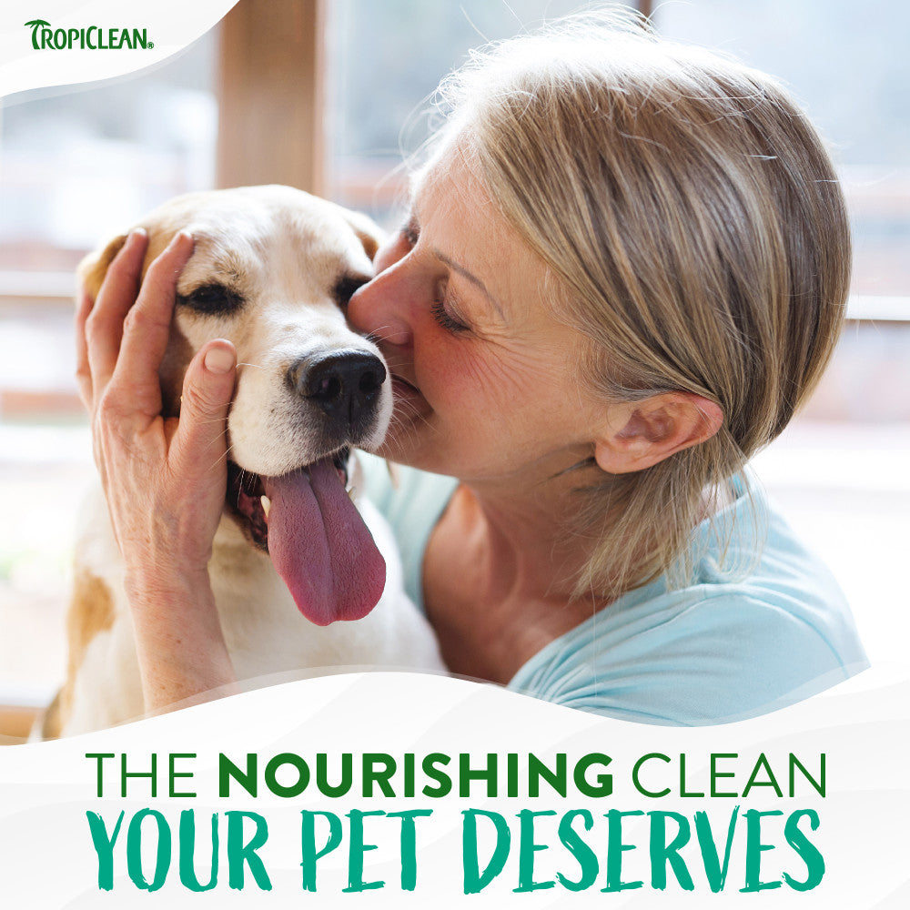 Woman kissing a dog with Tropiclean logo and text about pet care.