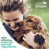 Woman hugging a dog with TropiClean Fresh Breath branding and product benefits text.