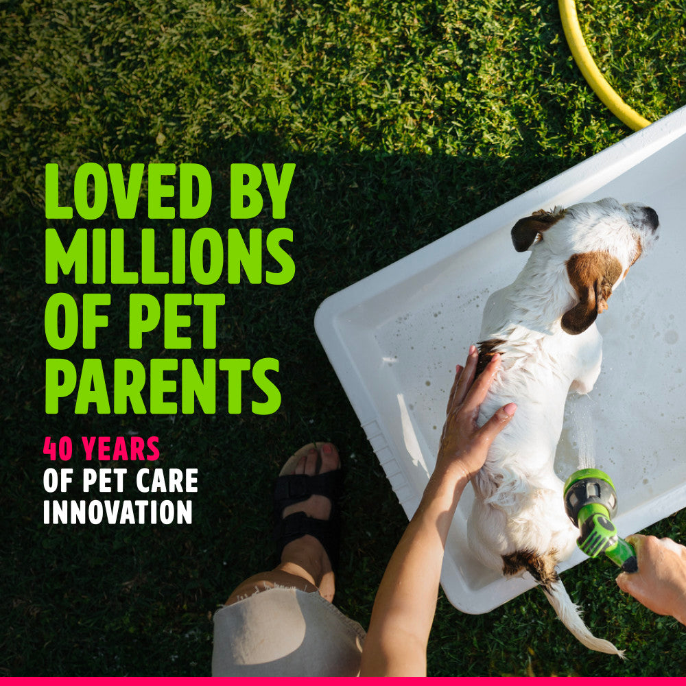 TropiClean EnduraScent Raspberry Lime Deodorizing Shampoo. Person washing a dog with text about pet care innovation on a grassy background