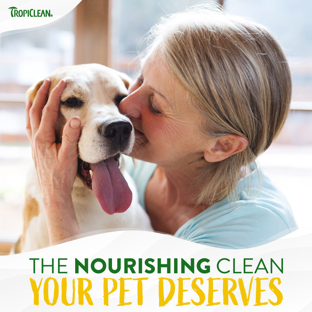Woman kissing a dog with TropiClean branding and text about pet care.