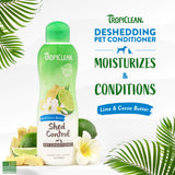 TropiClean Lime & Cocoa Butter Shed Control Conditioner for Pets bottle with lime and cocoa butter ingredients on a white background with green leaves.