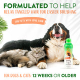 Dog and cat lying together with a bottle of TropiClean Papaya & Coconut 2-In-1 Shampoo and Conditioner for Pets
