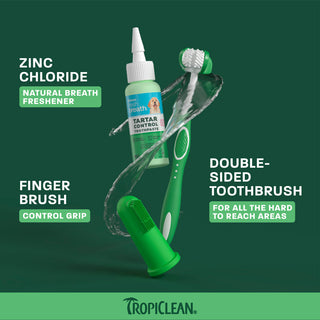 TropiClean dental kit with green double-sided toothbrush and mint-flavored tartar control toothpaste bottle on green backgrou