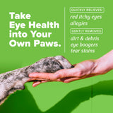 TropiClean HomeVet Soothing Eye Wash for Dogs & Cats. Dog paw being held by a hand with text on a green background
