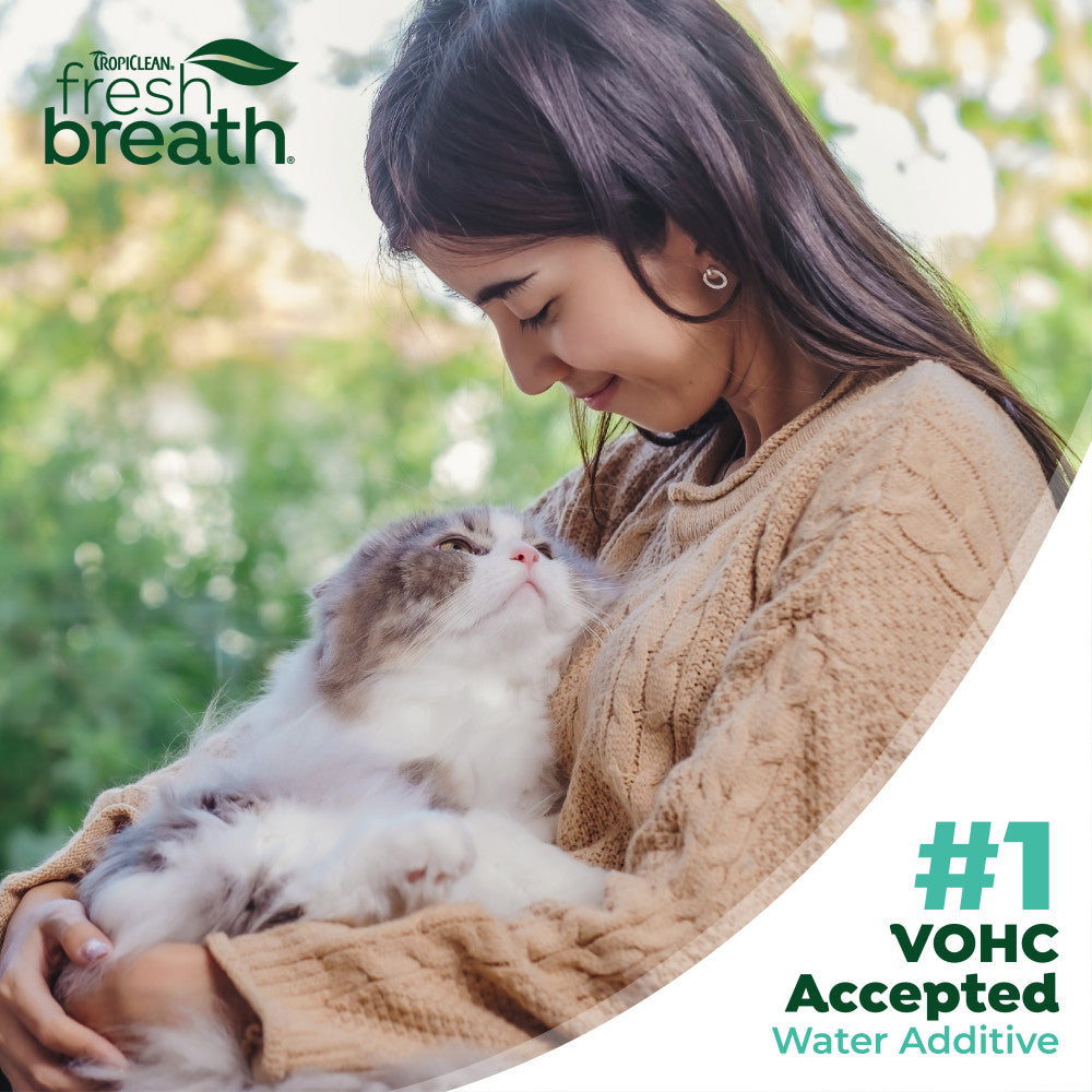 Woman holding a cat with Fresh Breath logo and text about VOHC acceptance. Fresh Breath by TropiClean Oral Care Water Additive for Cats