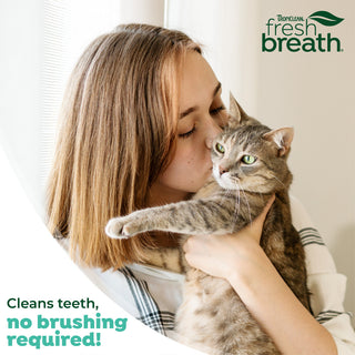 TropiClean Fresh Breath No Brushing Dental & Oral Care Gel for Cats. Woman kissing a cat with TropiClean Fresh Breath logo and text about dental care.