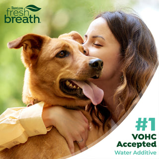 Woman hugging a dog with 'TropiClean Fresh Breath' branding and text about VOHC acceptance.