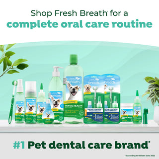 Assorted TropiClean Fresh Breath pet dental care products on a white surface with a green background, featuring the brand 'Fresh Breath'.