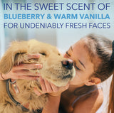 Woman kissing a dog with text about blueberry and warm vanilla scents.
