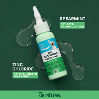 TropiClean Fresh Breath dental gel bottle with white cap and applicator, displayed on green background with product informati