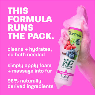 TropiClean deep cleanse bottle being held. text, 