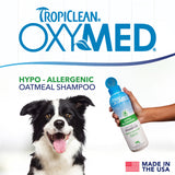 TropiClean OxyMed shampoo bottle with a dog and hand holding it on a white background