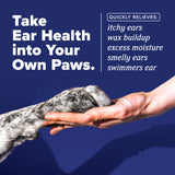 Dog paw being held by a human hand with text about TropiClean HomeVet Enzymatic Ear Wash for Cats & Dogs