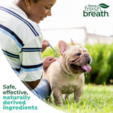Woman with a dog with 'TropiClean Fresh Breath' branding 