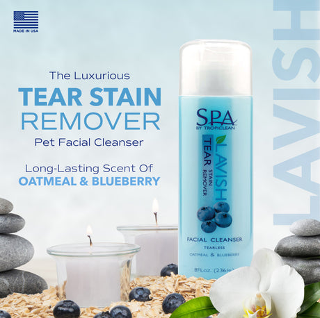 Spa by TropiClean tear stain remover bottle with blueberry and oatmeal elements on a light blue background.