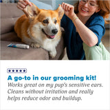 Woman petting a dog with a TropiClean HomeVet Medicated Dog Ear Drops, text about product in grooming kit effectiveness.