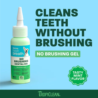 TropiClean Fresh Breath No Brushing Dental Gel in 2oz bottle with mint-green liquid and white applicator cap on blue backgrou