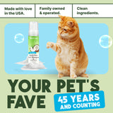 Cat with a bottle of TropiClean Dander Reducing Waterless Cat Shampoo with text about family ownership and product features.
