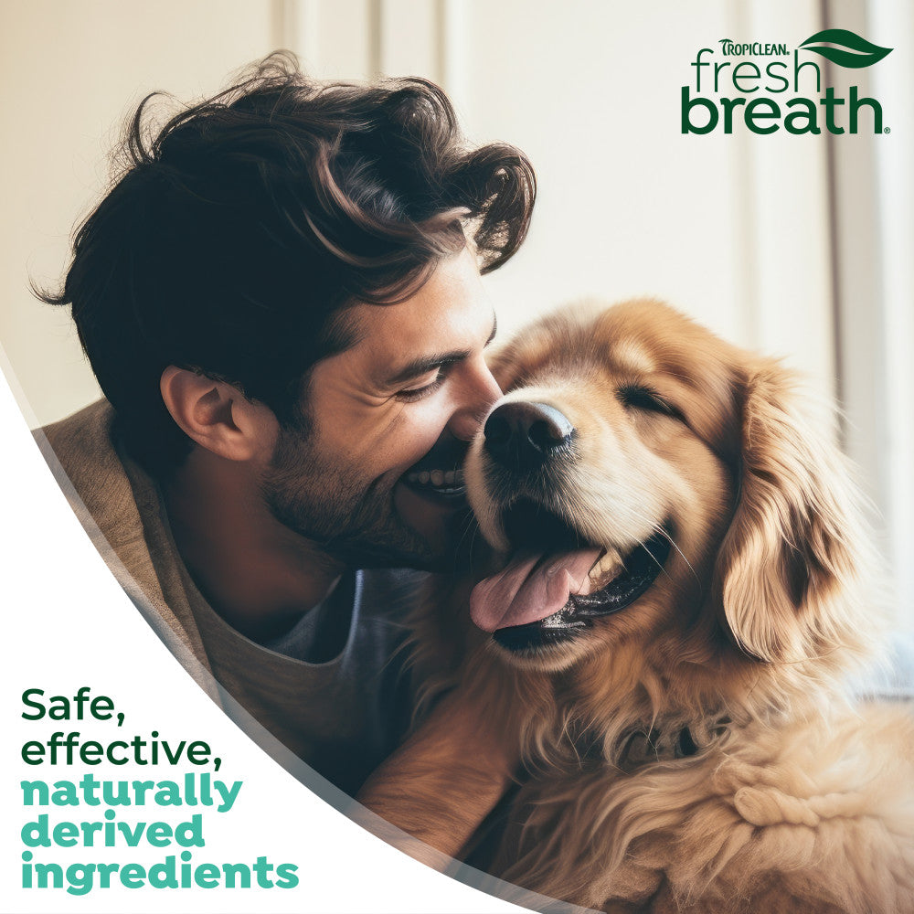 Man and dog with TropiClean Fresh Breath branding and product description text.