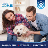 Couple with a dog on a couch, Tropiclean OxyMed branding visible