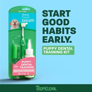 TropiClean Fresh Breath puppy dental training kit with soft-bristled toothbrush, gel bottle, and finger brush on light blue b